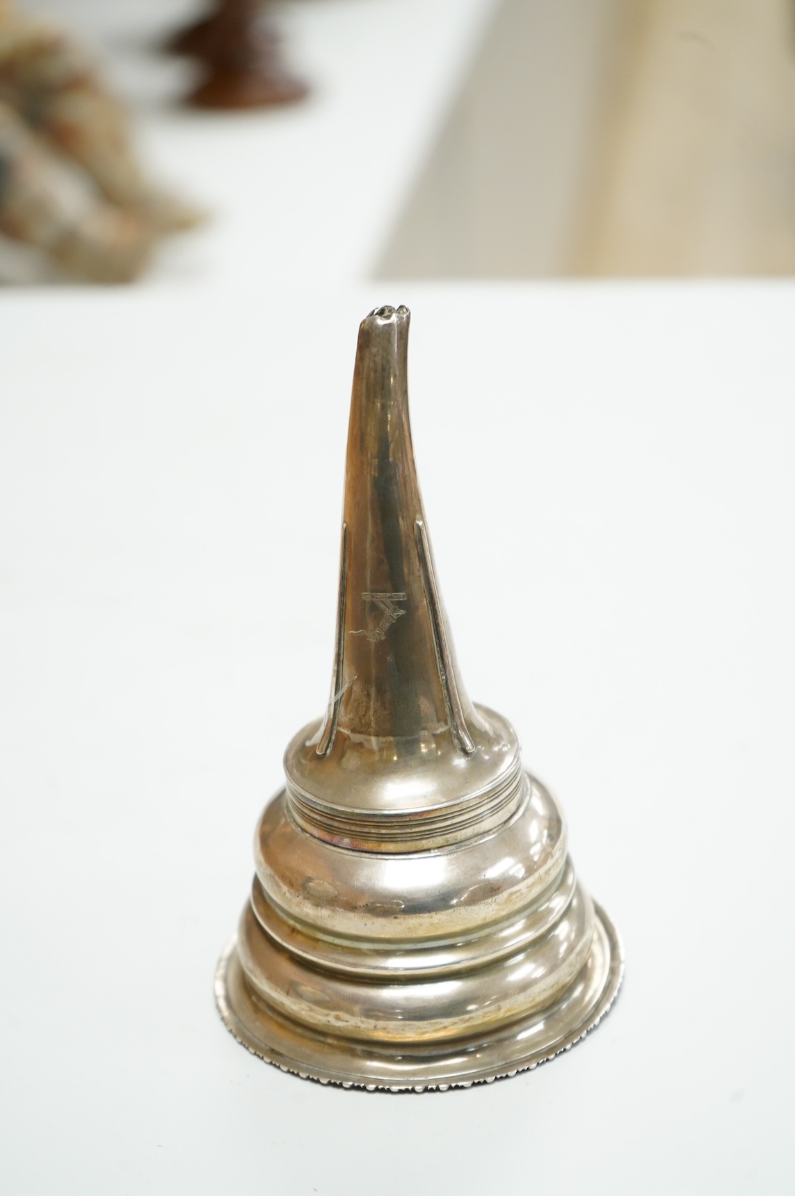 A George III silver wine funnel, with shell thumbpiece, marks rubbed, 14.5cm.